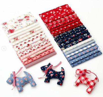 10-inch layer cake fabric bundle with stacks of floral prints and small fabric cutouts