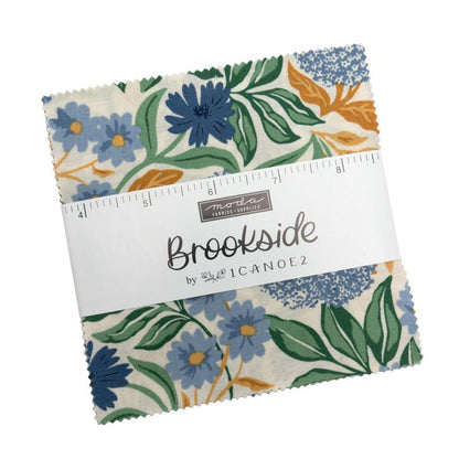 Charm pack of floral quilting squares, blue green orange prints on white background