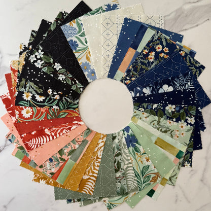 Circular display of assorted floral and botanical fabric strips in coordinated colors
