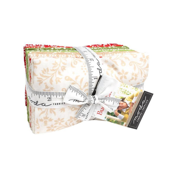 Festive christmas fabrics in a bundle tied with a Moda ribbon
