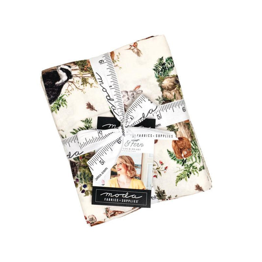 Collection of fabric swatches with nature-themed designs and a ruler ribbon, featuring the Moda brand.