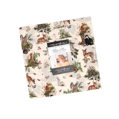 A layer cake featuring a collection of fabric swatches with various patterns and the Fable & Fern and a Moda label branding.