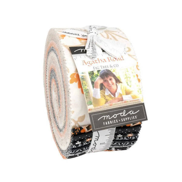 A jelly roll collection of fabric strips with various patterns and colors, featuring the brand 'Agatha Road' and 'Moda' in a country theme.