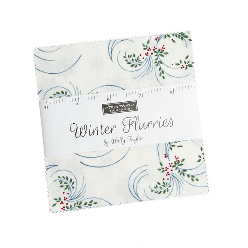 Fabric charm squares with blue swirls and red floral accents