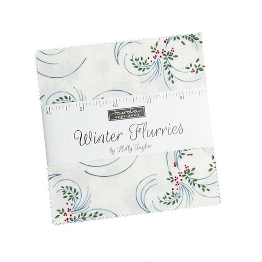 Fabric charm squares with blue swirls and red floral accents