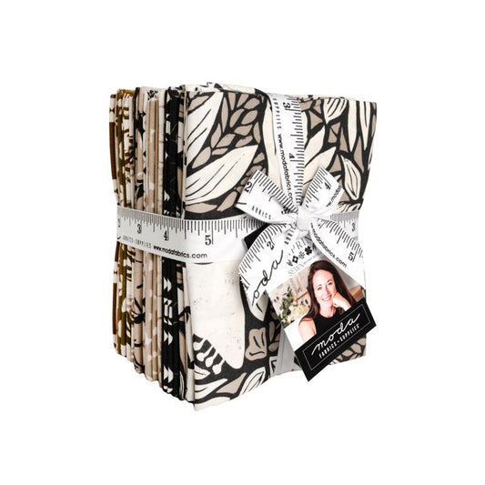Collection of fabric swatches in a bundle with a tied ribbon 'Imprint Sewn by Amy Schelle Moda' branding.