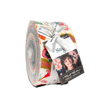 Colorful patterned fabric jelly roll bundle with multiple print fabrics, wrapped in labels.