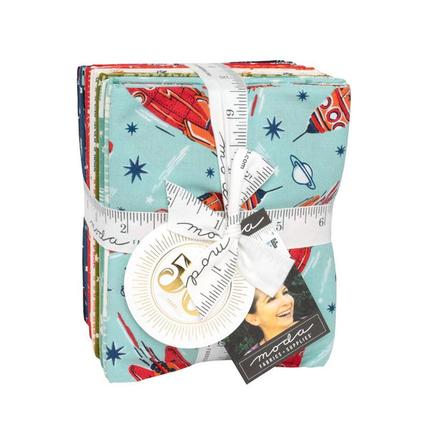 A bundle of fabric fat quarters wrapped with a white ribbon, featuring a space-themed print with red rockets, blue stars, and a light blue background. A round white tag and a black 'Made by Martha' brand tag are attached.