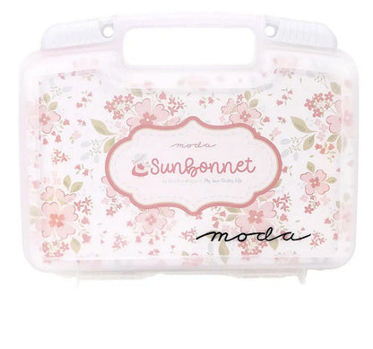 Sunbonnet quilt kit storage bin front with pink floral pattern and logo label