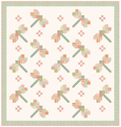 Cream quilt fabric with repeating sunbonnet blocks, patch motifs, and teal border