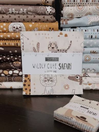 Stack of safari animal fabric charm squares in beige, brown, and light neutral tones