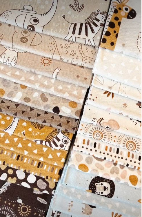 Close-up of safari-pattern charm squares with animals, trees, and dotted motifs