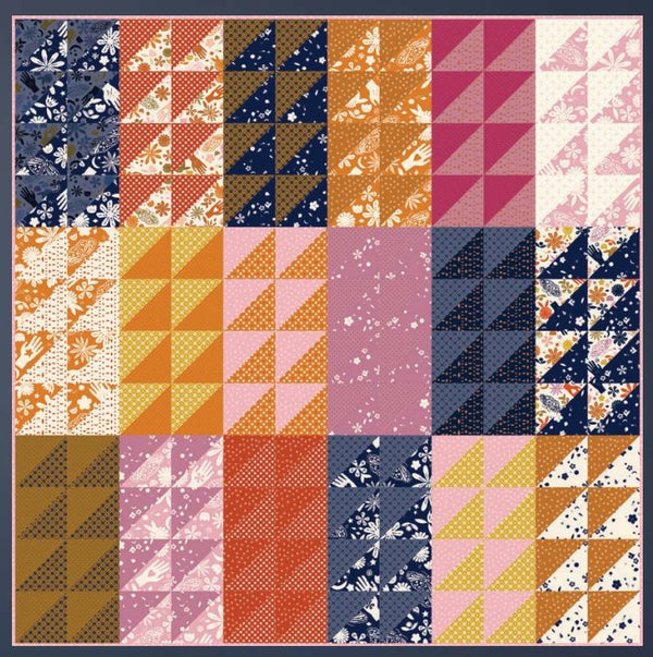 Patchwork moon-themed quilt with multicolor geometric and floral blocks, square design