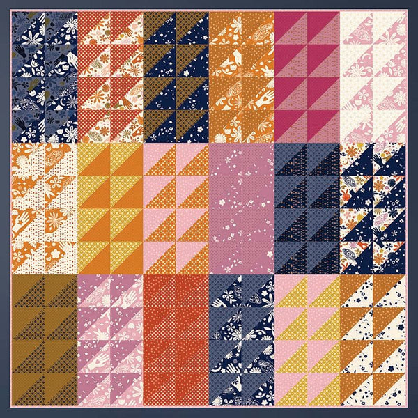 Patchwork quilt pattern layout with navy, orange, pink, and cream fabric blocks