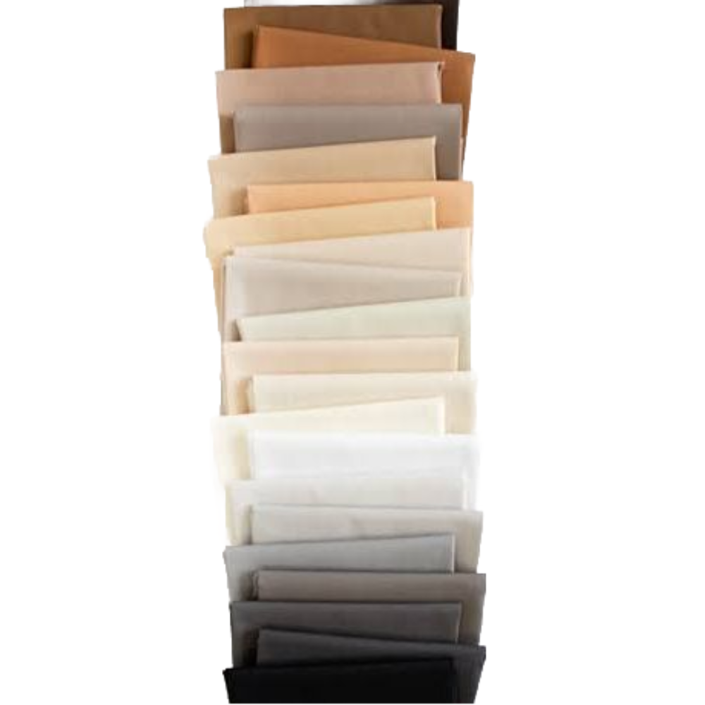Stack of folded solid fabric fat quarters in light, beige, and dark grey shades