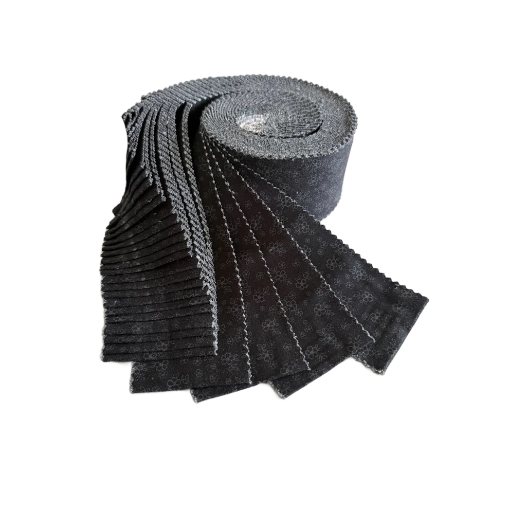 Black tonal calico floral fabric roll, tightly stacked strips in a curved view