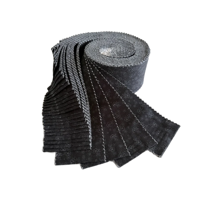 Black tonal calico floral fabric roll, tightly stacked strips in a curved view