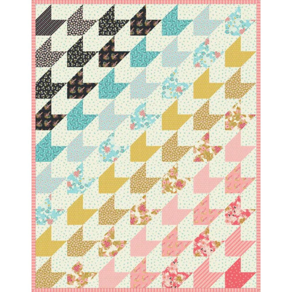 Patchwork quilt top with pinwheel blocks in teal, yellow, pink, and white