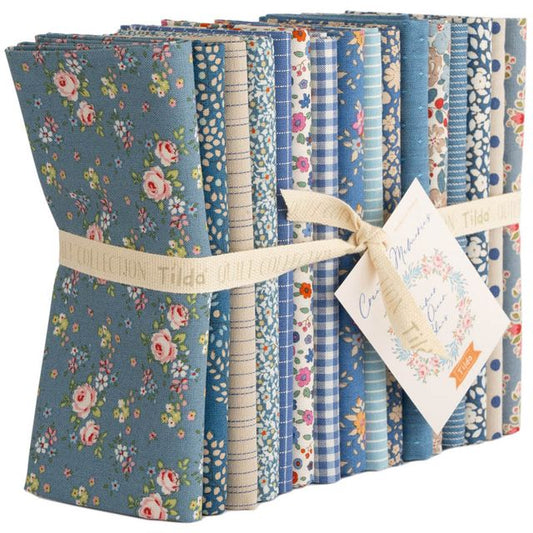 Tilda spring fat quarter bundle of blue floral and stripe cotton prints, tied with ribbon