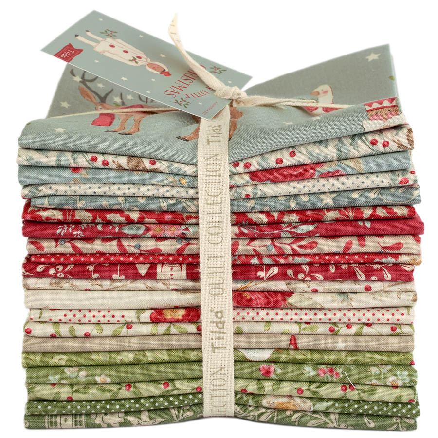 Christmas fabric fat quarter bundle stack tied with ribbon, red, green, and blue-gray prints
