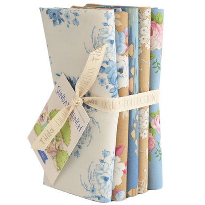 Floral fabric fat quarter bundle, blue and cream prints tied with beige ribbon